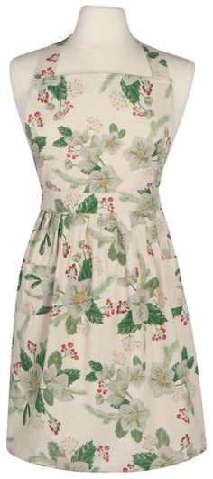 a white dress with green and red flowers on the front, it is made out of fabric