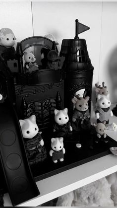 black and white photo of toys on shelf in room