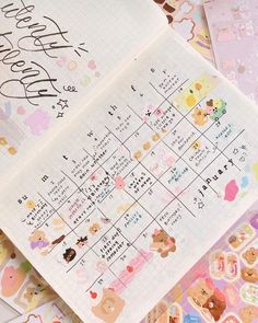 an open planner with stickers on it sitting next to other papers and paper decorations