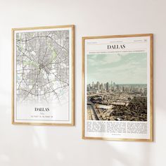 two framed maps hang on the wall next to each other in front of a city map