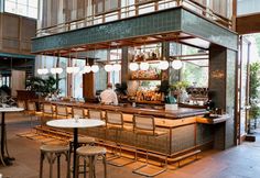 a bar with lots of stools and tables in the middle of an open floor plan