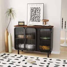 a living room with a black and white rug, two baskets on top of the cabinet