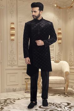 This black sherwani is adorned with delicate cutdana and shimmering sequins, making it an exquisite choice for sangeet ceremonies or reception nights. The perfect choice for any wedding, this sophisticated piece will have you looking and feeling your best. Black Sherwani, Mens Sherwani, Black