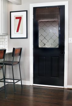 a black door and some chairs in front of a white wall with the words 7 expensive diy window privacy film