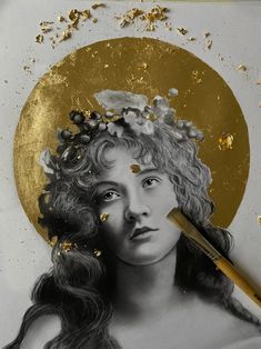 a woman's face with gold flecks on it and a brush in her hair