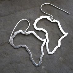 I have sent my 'African Love' necklace to customers in all corners of the world, so because this design is such a hit, the natural next step was to make.. earrings! Because who doesn't Love big bold Africa's dangling from their ears ? -d e s c r i p t i o n- Completely handmade by me - I sawed the African continent out of sterling silver sheet using my little jewellers saw. I then sawed another Africa out the middle, leaving a nice & sturdy 2mm thick outline. The piece was given a shiny brus Unique Silver Jewelry With French Hook, Silver Sterling Hoop Earrings With French Hook, Silver Sterling Silver Jewelry With French Hook, Africa Outline, Africa Continent, Africa Earrings, Map Of Africa, African Love, African Map