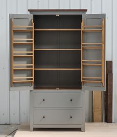 an open cabinet with drawers and shelves in it