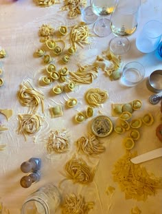 the table is covered with pasta and wine glasses