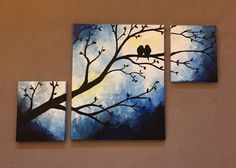 two birds sitting on a tree branch in front of blue and yellow sky with clouds