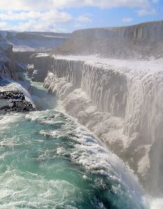 the water is crystal blue and green in this view looking down on niagara falls, canada