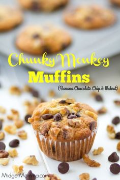 a muffin with chocolate chips and walnuts in it on a white surface next to other muffins