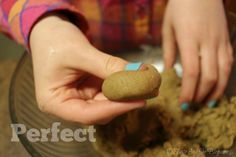 a person holding a rock in their hand