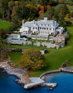 an aerial view of a large mansion with a swimming pool