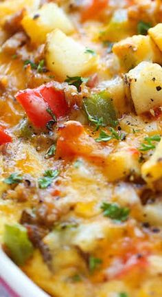 a casserole dish with potatoes, tomatoes and other toppings in a bowl