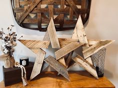 a wooden star sitting on top of a table next to a vase