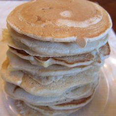 a stack of pancakes sitting on top of a white plate