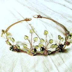 "A boho woodland tiara in copper and green with czech glass leaves and Swarovski crystal pearls. Boho Wedding Woodland Tiara Crown Lothlorien Spring Romantic Wedding Headpiece Rustic Wedding Wreath Fantasy Fairytale Elven Wedding Tiara This circlet is open at the back and can be pinned into virtually any size or shape of hairdo, there are also loops on either end to attach ribbons or even a veil if so desired- it is a very versatile piece. Our wire is nickel free and has a non-tarnish coat that Woodland Tiara, Elvish Wedding, Elven Wedding, Wedding Woodland, Fairy Crown, Elven Jewelry, Jewelry Ear, Wedding Wreath, Gold Bar Earrings