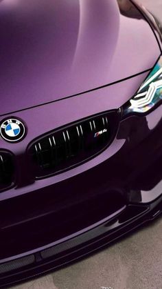 the front end of a purple bmw car