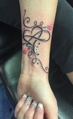 a woman's hand with a tattoo on it and hearts in the shape of a heart