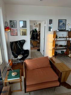 a living room filled with furniture and pictures on the wall