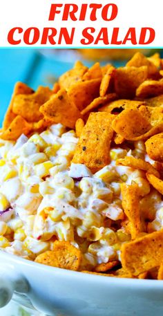 a white bowl filled with corn salad and tortilla chips