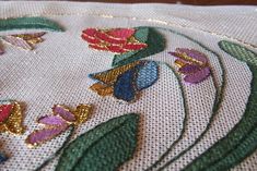 a close up view of some flowers on a piece of cloth with sequins