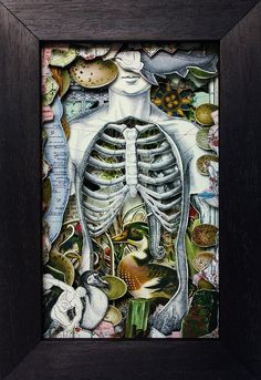 a painting with a skeleton surrounded by other items in black wood framed on white wall