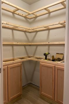 an unfinished kitchen with wooden cabinets and tools