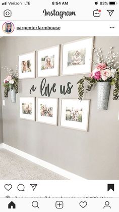 a wall with pictures and flowers hanging on it's side, which says love us