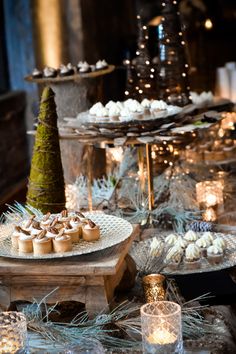 an assortment of desserts and candles on a table