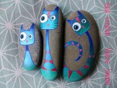 three painted rocks with cats on them sitting next to each other in the shape of letters g