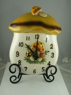 a white and gold clock sitting on top of a table