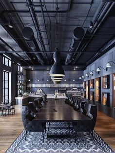 an empty conference room is shown with black chairs and large wooden table in the center