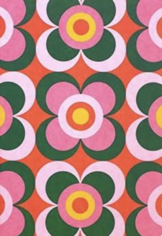 an orange, pink and green flower pattern with circles in the center on a red background