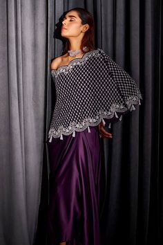 Purple one shoulder cape with all over crystal jaal hand embroidery. Paired with a draped dhoti skirt and an inner. - Aza Fashions Festive Evening Dupatta In Cape Style, Festive Evening Cape-style Dupatta, Evening Festive Cape Dupatta, Festive Evening Cape-shaped Dupatta, Festive Evening Cape Dupatta, Party Dupatta With Zari Work And Cape Sleeves, Elegant Cape Dress With Zari Work, Elegant Cape Dupatta For Eid, Pre-draped Saree With Cape Sleeves For Eid