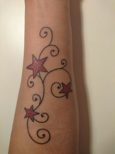 a woman's arm with stars and swirls on it