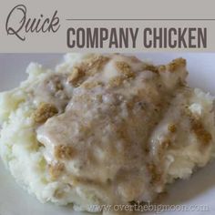 a white plate topped with mashed potatoes covered in gravy