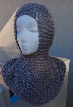 a mannequin wearing a knitted hat and scarf