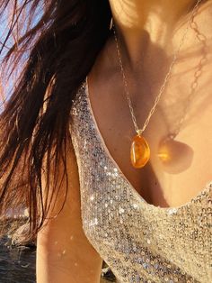 Pendant material and details : * Natural Baltic amber  * Type of Amber : Transparent  * Color of Amber : Honey , Cognac  *  * Metal :Gold 14K (585*) hallmark & brand logo AMAD  * Size of pendant : 2,9 * 2,1 cm