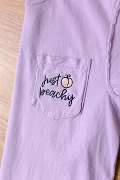 What's better for summer than a lavender peachy tee? Pair this top with your favorite pair of shorts, or a flirty twirl skirt! Embroidered on your choice of a Comfort Colors orchid pocket tee, pocket long sleeve, or crewneck sweatshirt. Comfort Colors is unisex sized. This means the sizing is boxy, not fitted like women's, but it is not oversized. It is true to size. Tee Specifications: 6.1 oz., 100% ring spun cotton Soft-washed garment-dyed fabric Double-needle collar Twill taped neck and shoul Cotton Tops With Pockets For Beach Season, Lavender Trendy T-shirt For Summer, Trendy Lavender T-shirt For Summer, Trendy Lavender Summer T-shirt, Lavender Crew Neck T-shirt For Summer, Casual Purple Tops For Beach Season, Purple T-shirt For Summer Loungewear, Summer Purple T-shirt For Loungewear, Trendy Lavender Tops For Beach