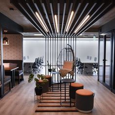 an office with wooden flooring and modern furniture in the center, surrounded by glass walls