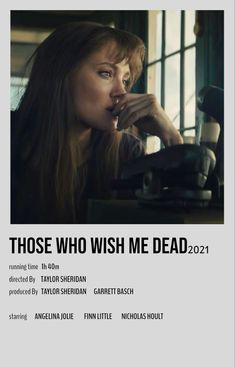 the poster for those who wish me dead is shown in front of a woman sitting at a desk