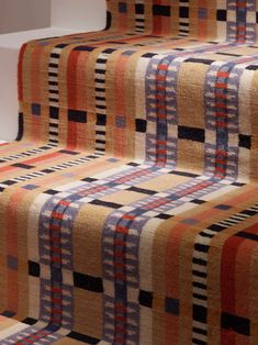 the carpeted stairs are lined with multicolored squares