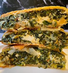 three pieces of food are stacked on top of each other, with cheese and spinach