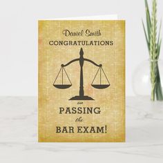 a congratulations card with the words passing the bar exam on it and a scale balance