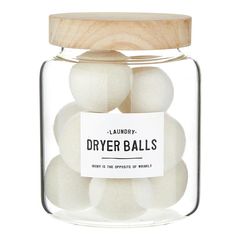 a glass jar filled with white dryer balls