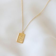 "In addition to keeping you safe during travels, legends proclaim that St. Christopher also shields you from the dangers of a storm. This necklace features a gold rectangular medallion depicting Saint Christopher on a dainty chain. The modeling photo shows the 18 in. necklace length version. The sparkly gold choker necklace can be found here: https://www.etsy.com/listing/679167388/sparkly-gold-choker-gold-filled-choker Oval St. Christopher medallion can be found here: https://www.etsy.com/listin St Christopher Necklace, Square Necklace, St Christopher, Heavy Chain, Saint Christopher, Layered Necklace Set, Dainty Chain, Gold Choker Necklace, Gold Choker