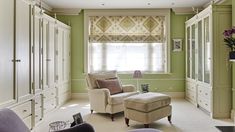 a living room filled with furniture and green walls