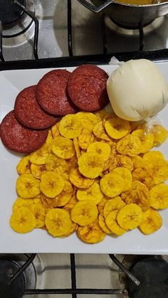 some food is laying out on a white plate next to other foods and cooking utensils