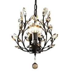 a chandelier with three lights hanging from it's center and leaves on the bottom